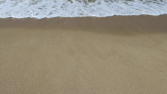 Wave and sand at the tropical beach. Beach slow motion  video