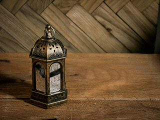 Ramadhan lantern or lamp, isolated in wooden background