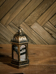 Ramadhan lantern or lamp, isolated in wooden background