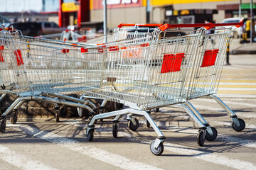 Empty shopping carts in shopping center parking.