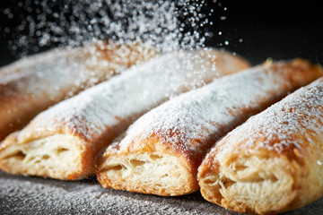 Sprinkle powdered sugar on pastry cookies