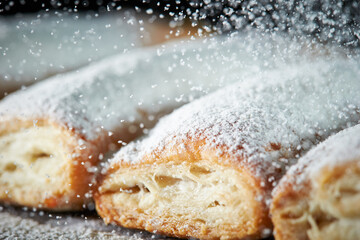 Sprinkle powdered sugar on pastry cookies