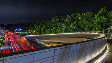 Arc-shaped pedestrian viaduct and red beautiful vehicle track,scenic green tree. Chiayi,Taiwan.for...