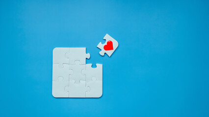 Puzzle pieces jigsaw with red heart on blue background, Awareness heart jigsaw puzzle  pieces, Business solutions, success and strategy, Problem solving, business success teamwork concept.