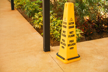 A yellow wet floor sign is a symbol of caution and warning, indicating a slippery and potentially hazardous area. It represents safety, prevention, and the need for attention and alertness in public 