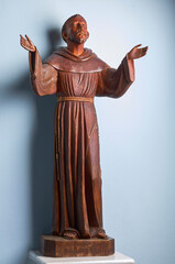 Vintage wooden statue of saint francis isolated in white background