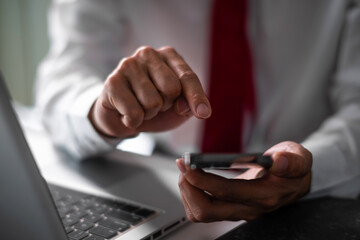Close up of business man hand using smart phone and tablet. business and technology concept