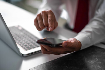 Close up of business man hand using smart phone and tablet. business and technology concept