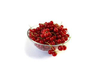 Isolated on white background red currant berries in a transparent plate