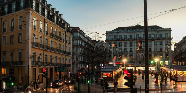 In Lisbon, Portugal, a street in the Chiado neighborhood is illuminated at night.