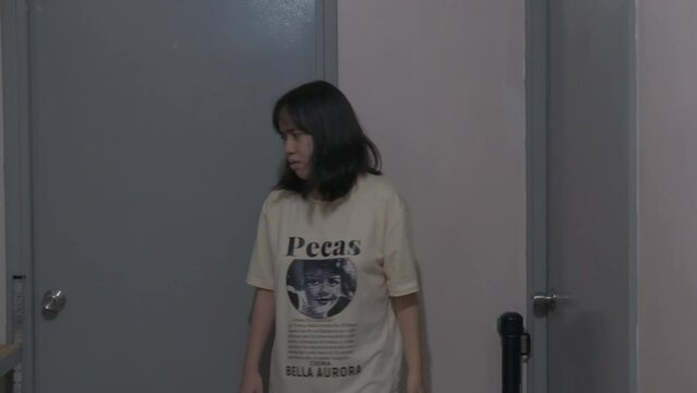 Sideview of woman extremely stressed, walks away and exits into room