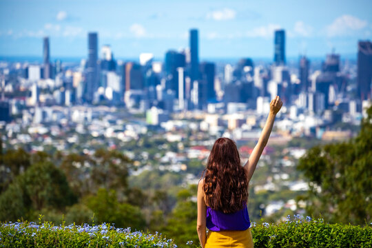 beautiful long haired hiker girl admiring the panorama of brisbane from the top of mount coot-tha, brisbane city during sunny day, hiking in brisbane