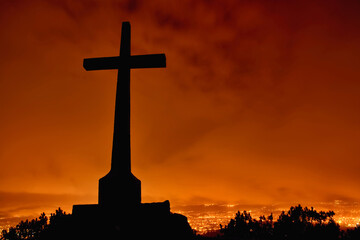 Christian cross on hill outdoors at sunrise. Resurrection of Jesus. Concept photo. Silhouette of...