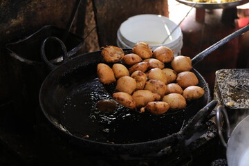 Frying Kachori in a Frying Pan at a street food stall , oily food