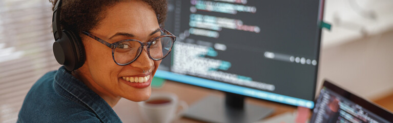 Female freelancer making new project as web designer and programmer on her computer at home office