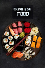 Traditional Japanese food dishes on black background, top view, copy space