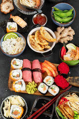 Traditional Japanese food dishes on black background, top view
