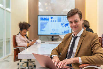 Young handsome successful businessman with different poses in a meeting room. Team lead in a meeting room. Manager at work.
