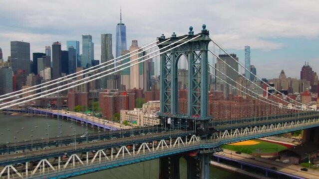 Cinematic Aerial of Manhattan Bridge with over east river   and FDR drove with Brooklyn Bridge and famous New York City buildings in background  downtown NYC and traffic across 