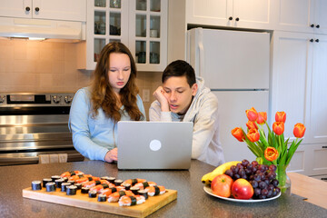 teenagers doing homework in the kitchen ordered sushi meet after school first date watch movie...