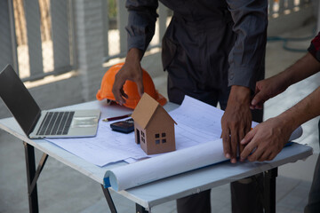 Engineering team consulting and analyzing building projects construction site .Home concept Offer Management