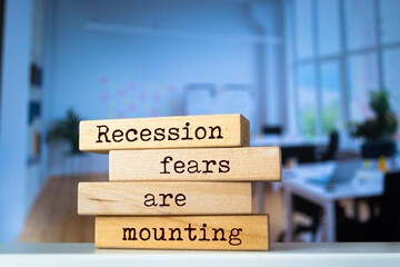 Wooden blocks with words 'Recession fears are mounting'. Business concept	