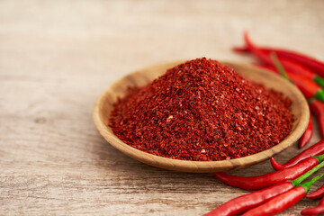 red chili pepper flake or ground powder coarse in wood bowl on wooden table food background. red chili pepper flake or ground powder coarse food. red chili pepper flake or ground powder coarse    