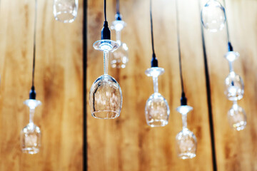 Small lamps from wine glasses. The idea of using objects in decorating a room. Foreground....