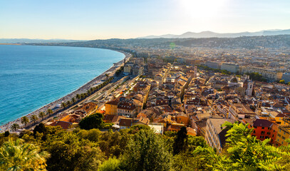 Nice sunset panorama with Vieille Ville old town district, Promenade des Anglais boulevard and beach at French Riviera of Mediterranean Sea in France