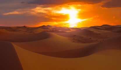 Naklejka na ściany i meble Beautiful sand dunes in the Sahara desert at sunrise with solar eclipse - Sahara, Morocco