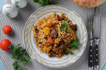 Beef with bulgur and vegetables such as pumpkin, carrots, onions and sun-dried tomatoes, View from above