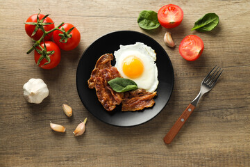 Fried bacon and egg - tasty breakfast, top view