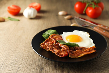 Fried bacon and egg - tasty breakfast composition