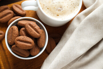 Concept of tasty snack for hot drink - cookies in the shape of coffee seeds