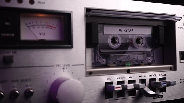 Inserting Cassette Tape With Wiretap Audio Recording in Vintage Deck Player From 1980s