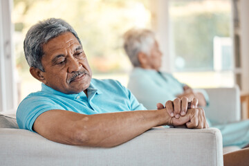 Angry, senior couple and fighting on a sofa about divorce, breakup and separation in their home....