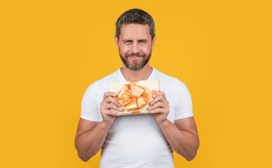 cheerful man hold gift box in studio. man with gift box for holiday. photo of man