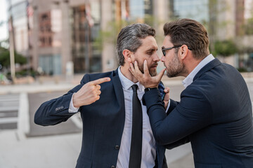 aggressive businessmen have business conflict. two businessmen have business conflict outdoor.