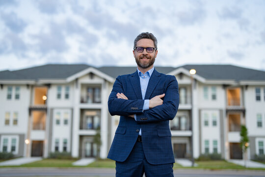 photo of happy man realtor in the suit outdoor at the house