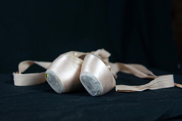 Pointe shoes on a black background close-up. © Natalia
