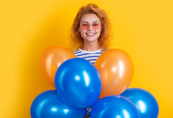 party woman with balloon in sunglasses. happy woman hold party balloons in studio.