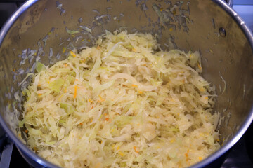 Chopped cabbage in a pot for bigos - a traditional Polish dish