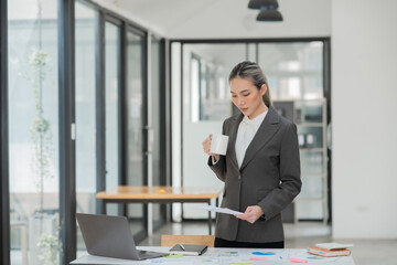 Young Asian businesswoman working on documents at office