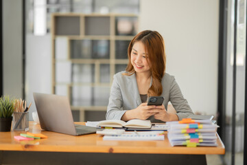 Asian businesswoman holding notebook about business, spending money