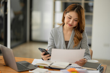 Asian businesswoman holding notebook about business, spending money