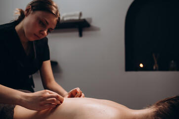 Obraz na płótnie Canvas Spa woman. Female enjoying relaxing back massage in cosmetology spa centre. Body care, skin care, wellness, wellbeing, beauty treatment concept