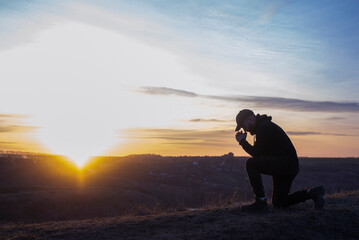 Prayer. A man prays on his knees. Repentance for sins. Kneeling