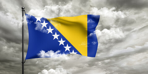 Bosnia and Herzegovina national flag cloth fabric waving on beautiful sky grey Background.