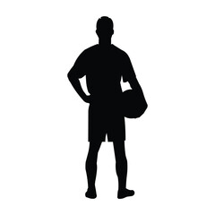 Football player silhouette stands with his and holds a ball in his hand
