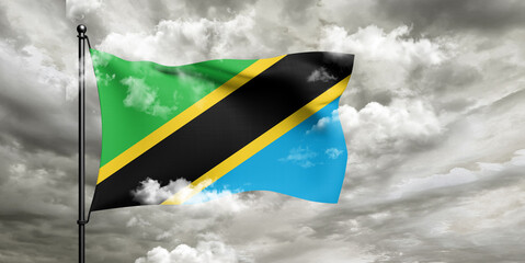 Tanzania national flag cloth fabric waving on beautiful sky grey Background.